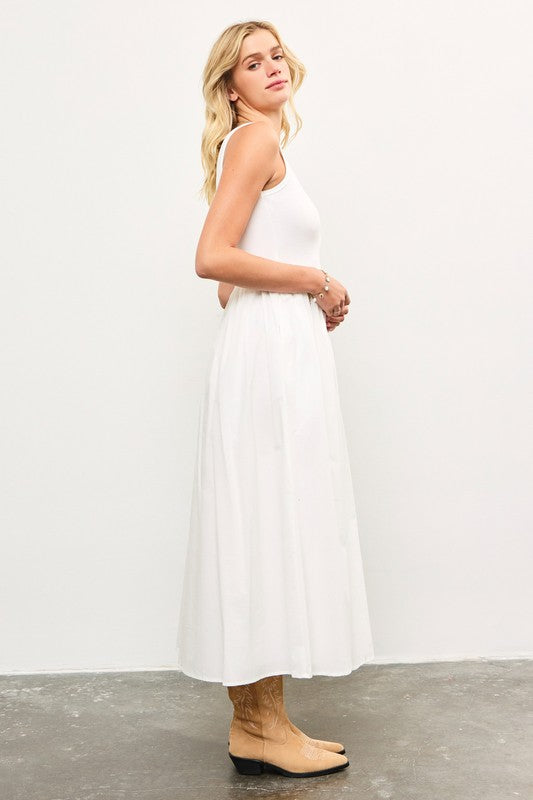 Flowy white dress styled with cowboy boots.