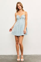 Front view of model wearing light blue braided denim mini dress