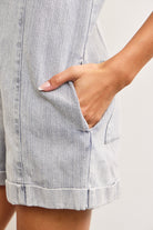 Close-up of button details on denim romper shorts