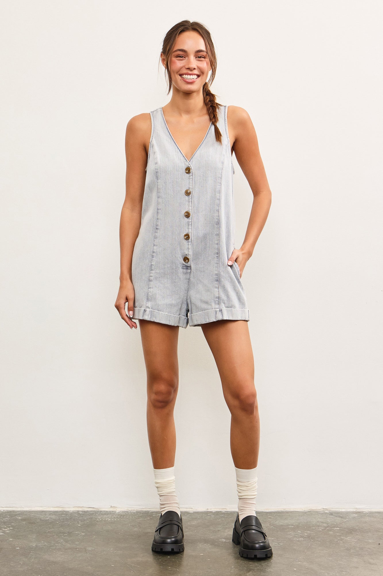 Model styling denim romper with loafers and socks